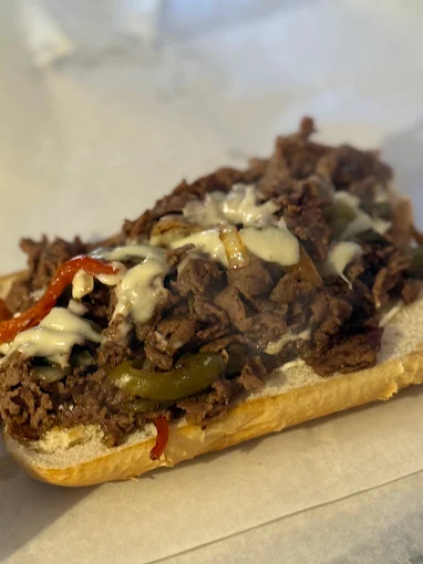 Philly cheesesteak sub loaded with peppers, onions and cheese from Asian Fusion, catering-ready